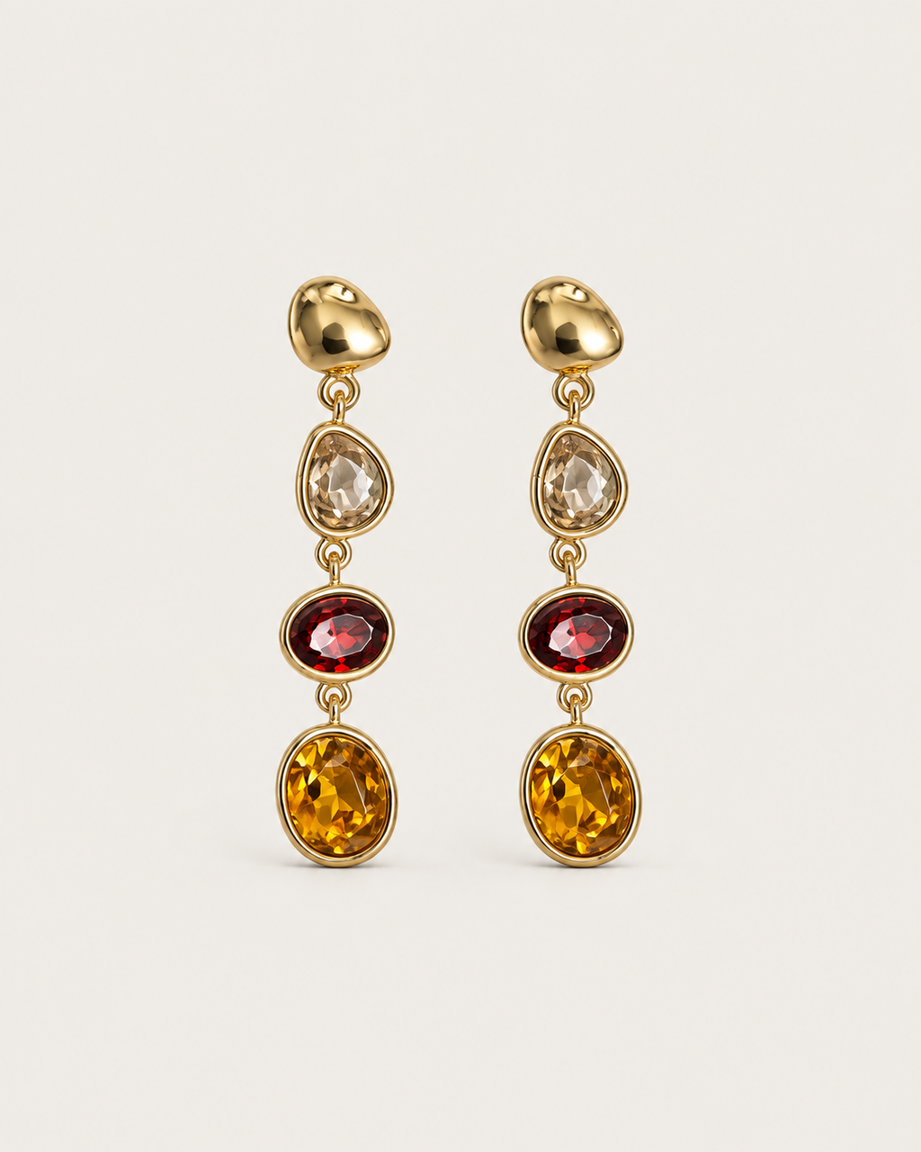 Pair of tiered drop earrings with clear, red and golden-brown accents in gold-tone frames, shown together.