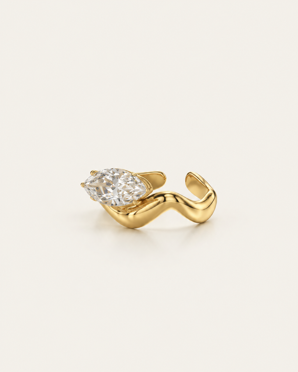 Gold-tone wave band ring with a raised clear stone accent, angled view showing the open back.