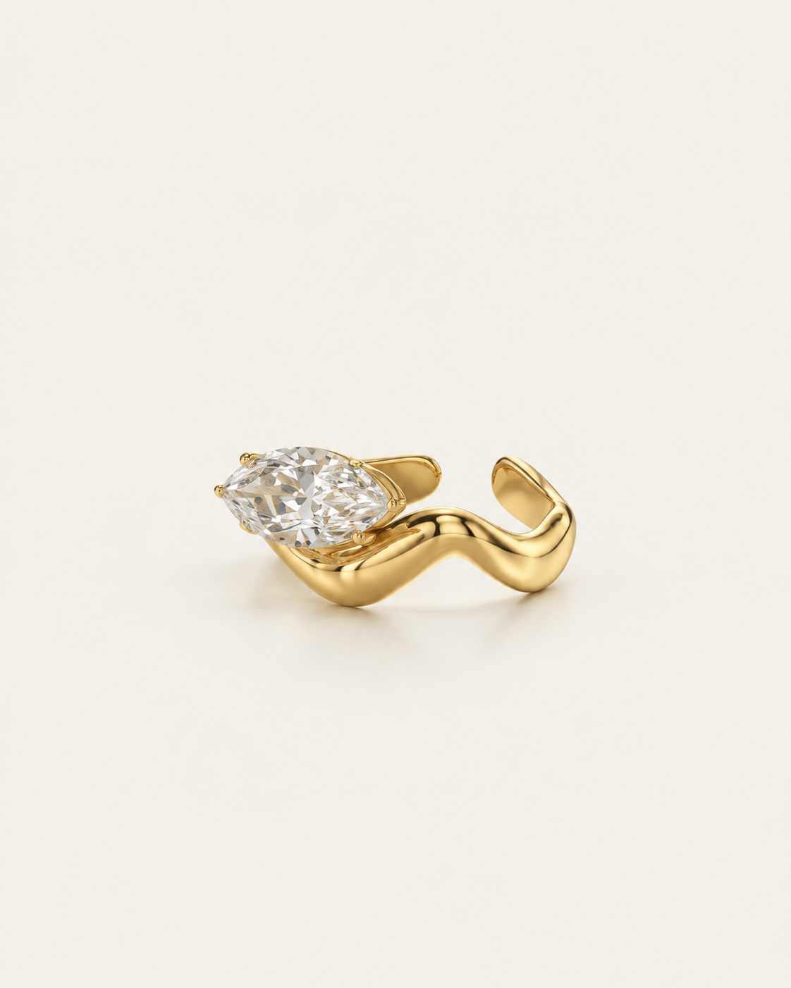 Gold-tone wave band ring with a raised clear stone accent, angled view showing the open back.