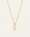 Gold-tone necklace with a white drop pendant, front view on a fine chain.