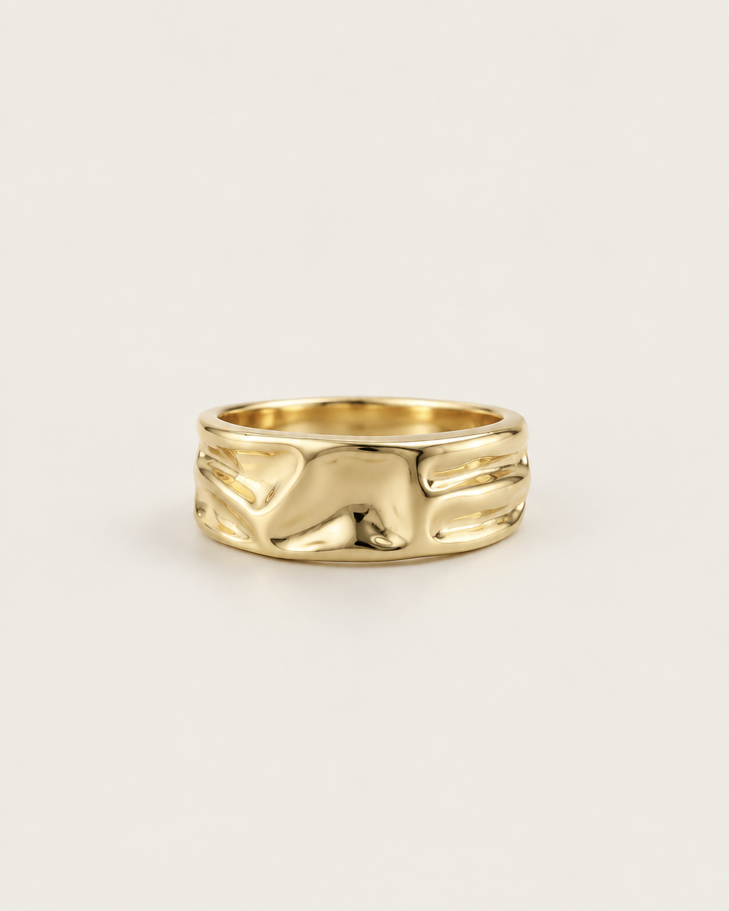 Gold-tone open band ring with a folded surface, front view.
