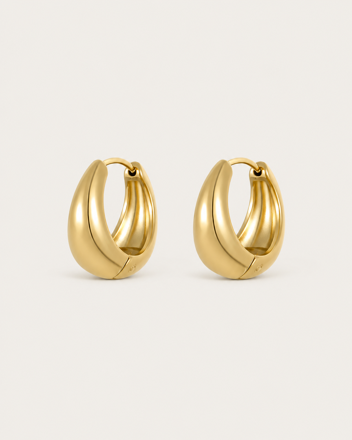 Pair of chunky gold-tone teardrop-shaped hoop earrings, shown together.