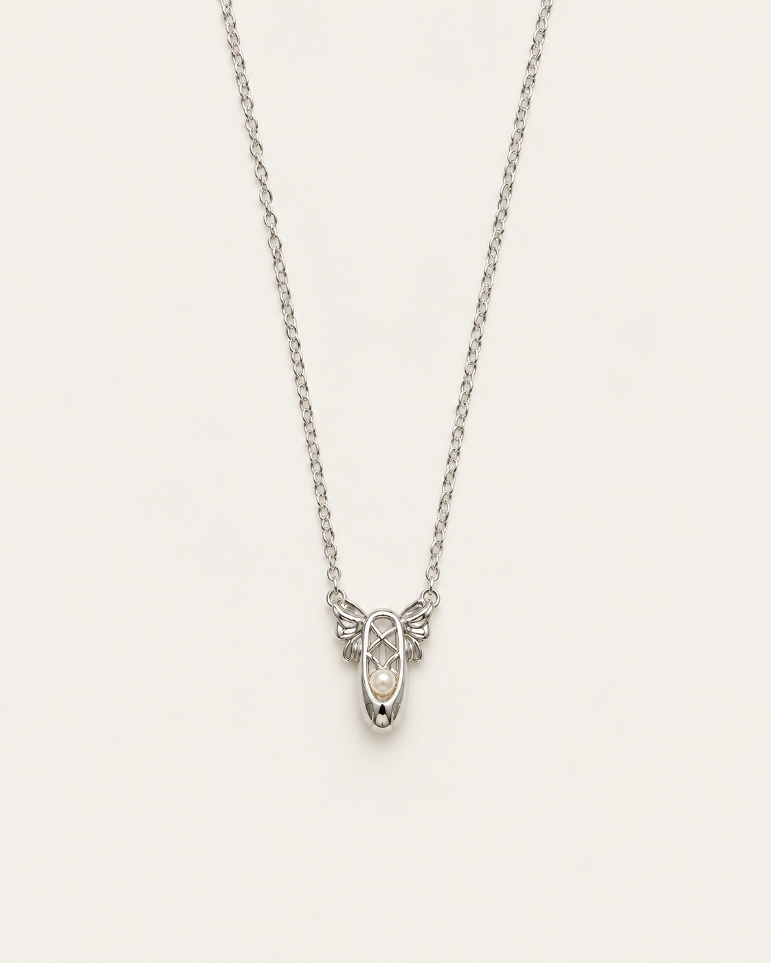 Silver-tone necklace with two ballet-slipper pendants, front view.