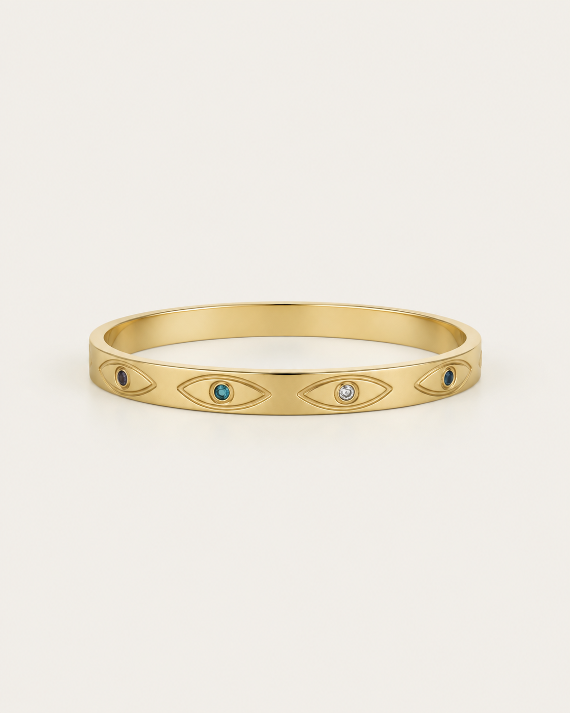 Gold-tone bangle with eye motifs and coloured centres, front view.