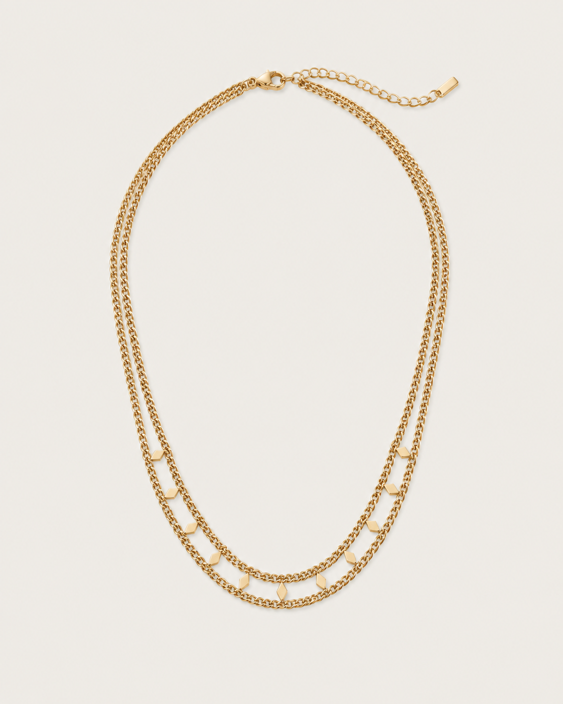 Gold-tone double-strand chain necklace with flat accents, laid out with the clasp visible.