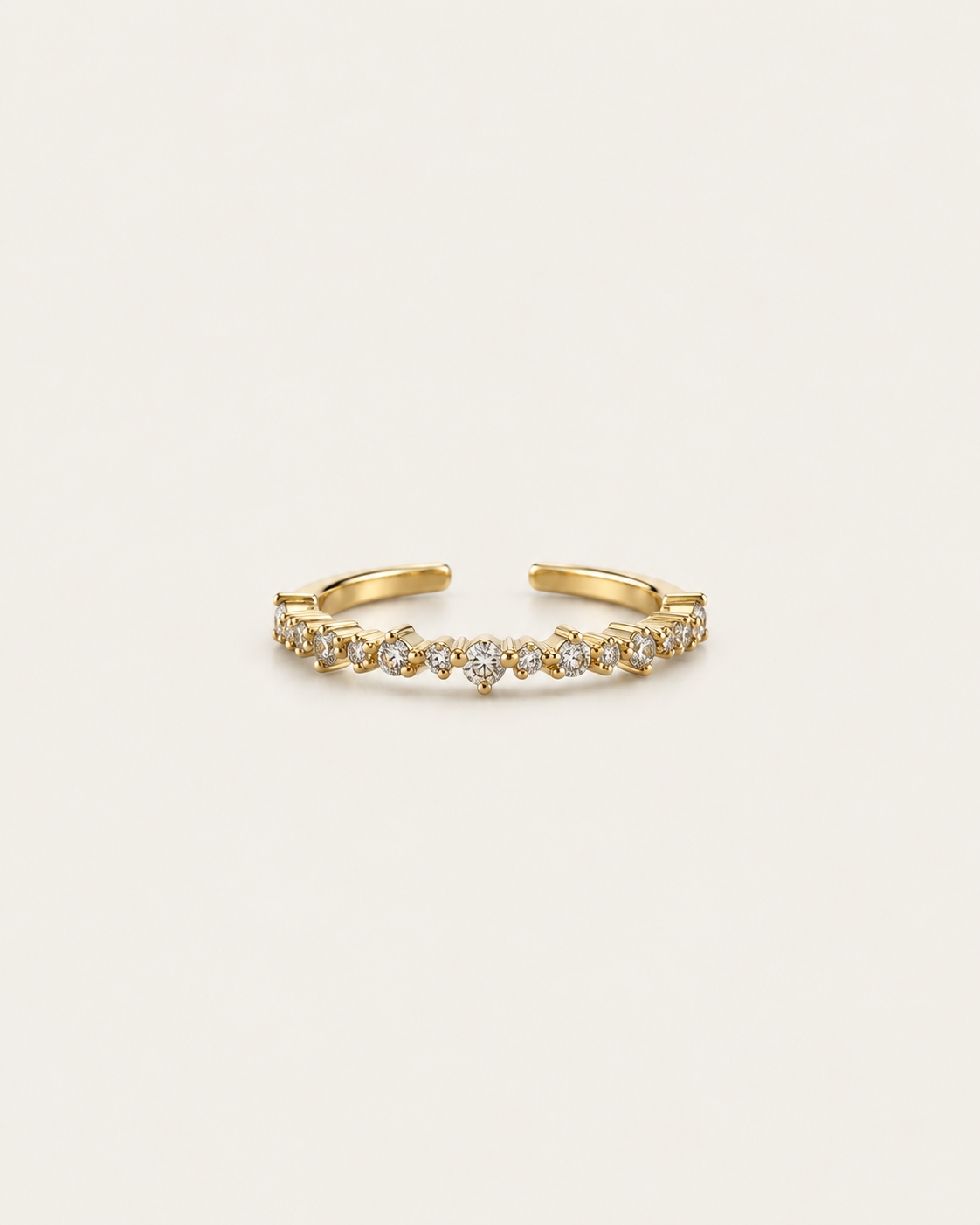Gold-tone band ring with a row of clear stone accents, front view.