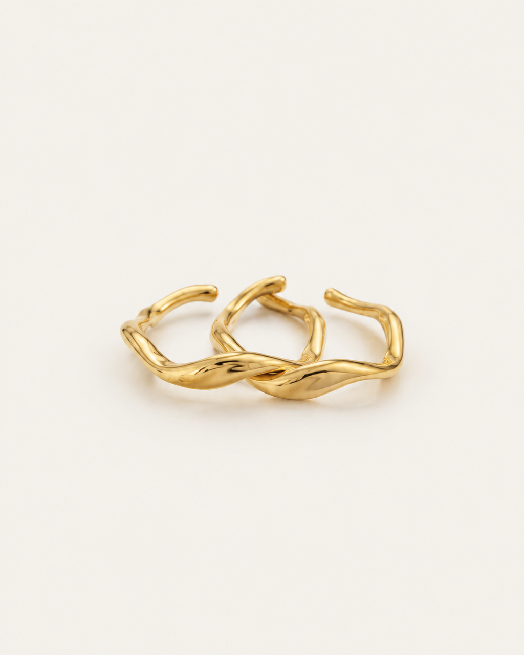 Set of two gold-tone wave stacking rings, shown side by side.