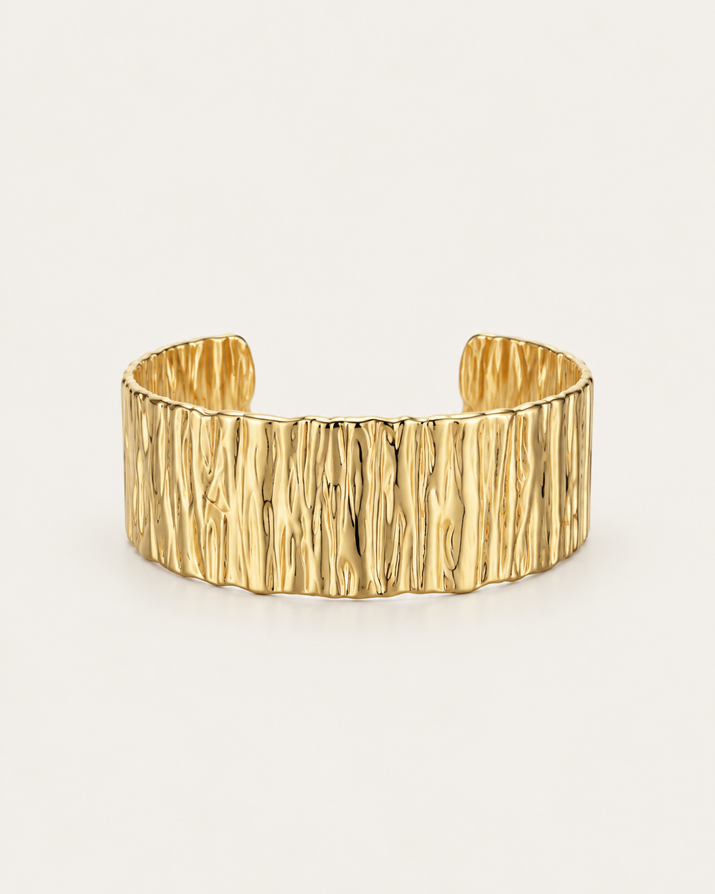 Wide gold-tone cuff bangle with a bark-like texture, front view.