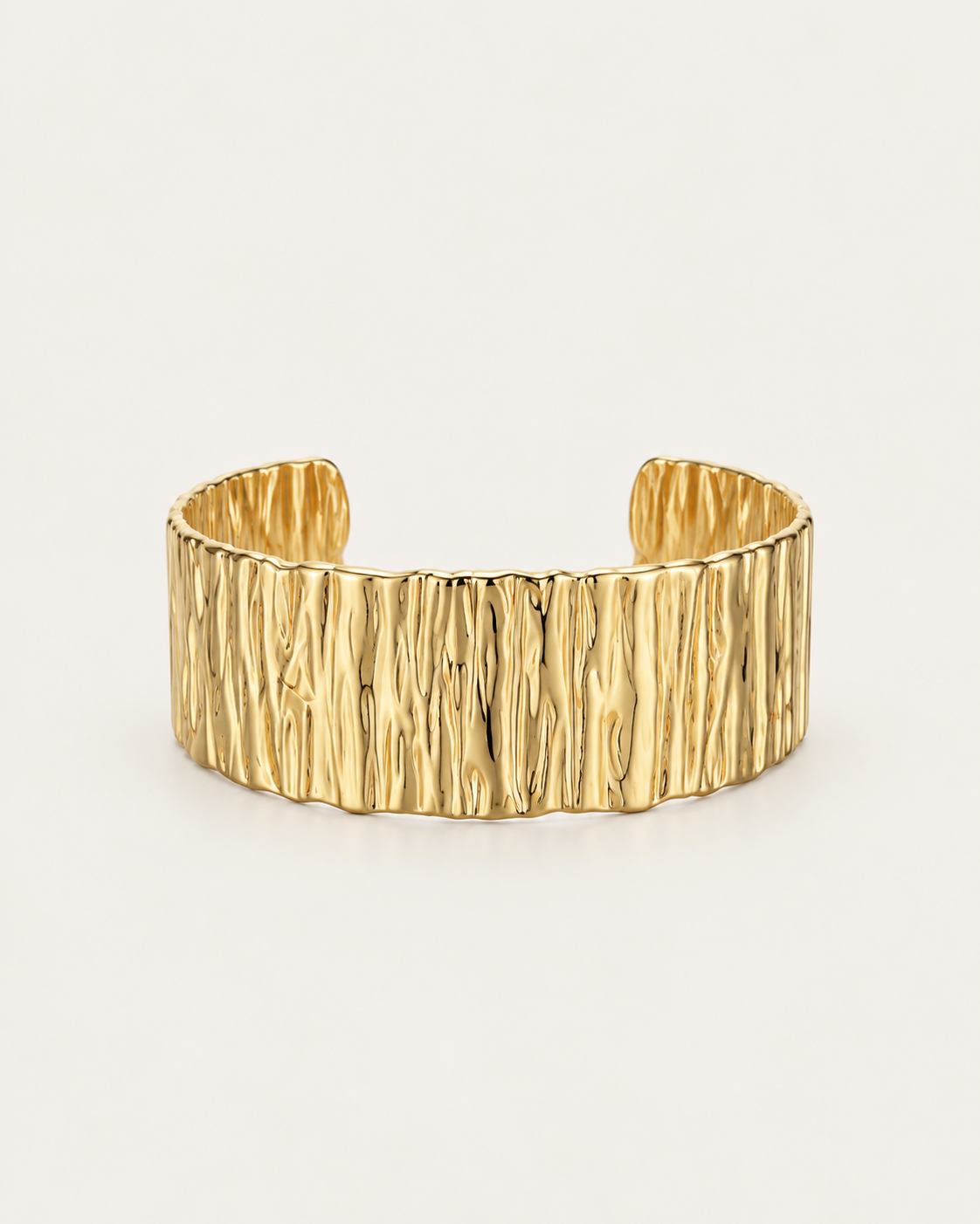 Wide gold-tone cuff bangle with a bark-like texture, front view.