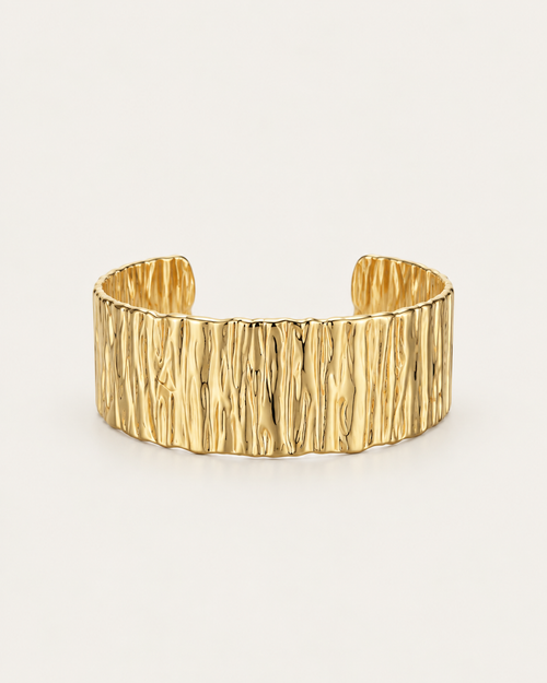 Wide gold-tone cuff bangle with a bark-like texture, front view.