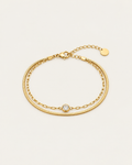 Gold-tone double-chain bracelet with a central stone accent, laid out with an extension chain.