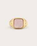 Gold-tone ring with a pale pink cushion-shaped accent, front view.