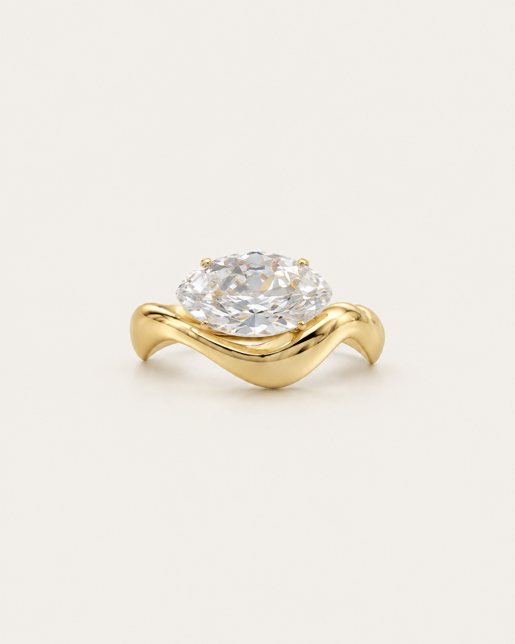 Gold-tone wave band ring with a raised clear stone accent, front view.