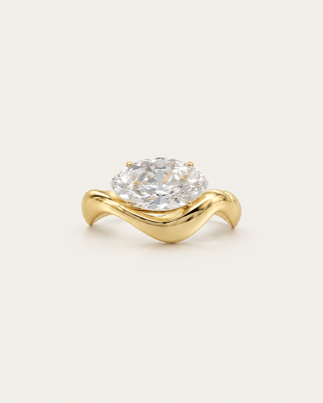Gold-tone wave band ring with a raised clear stone accent, front view.