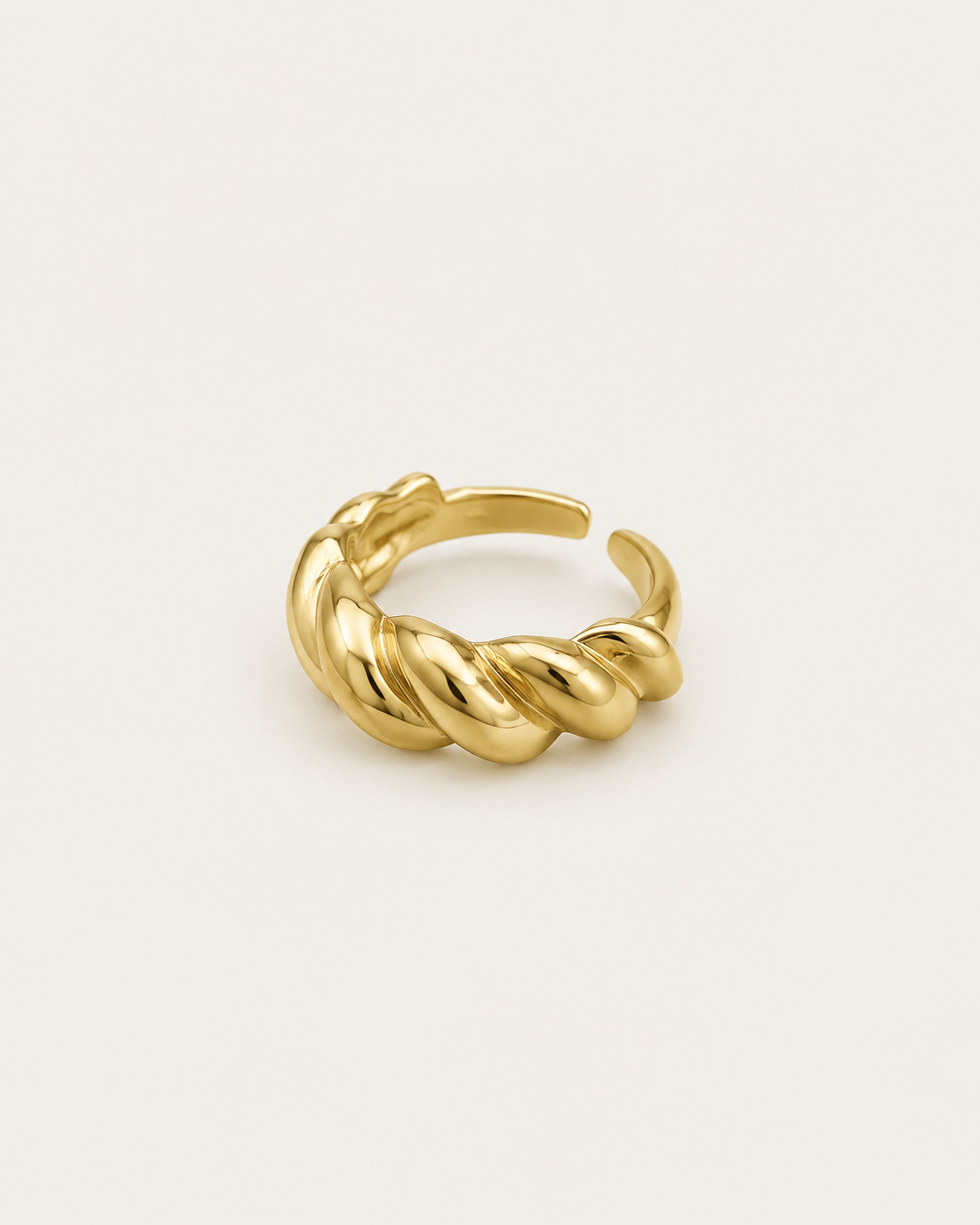 Gold-tone open band ring with a cable-twist pattern, angled view showing the open back.