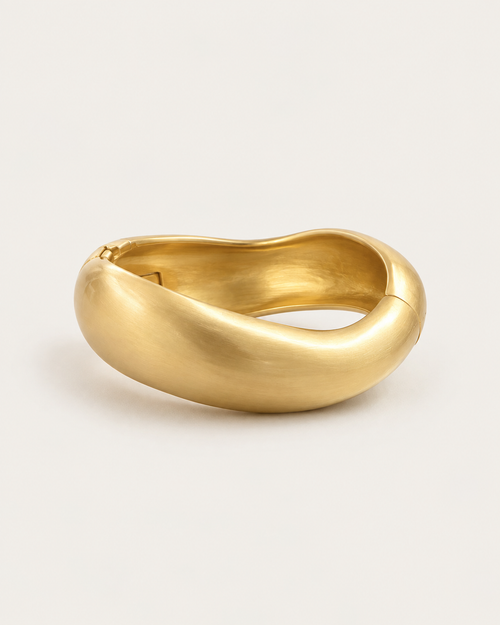 Gold-tone rounded contour bangle with a brushed-looking surface, front view.