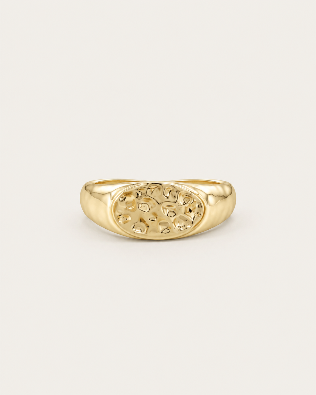 Gold-tone ring with a hammered oval dome, front view.