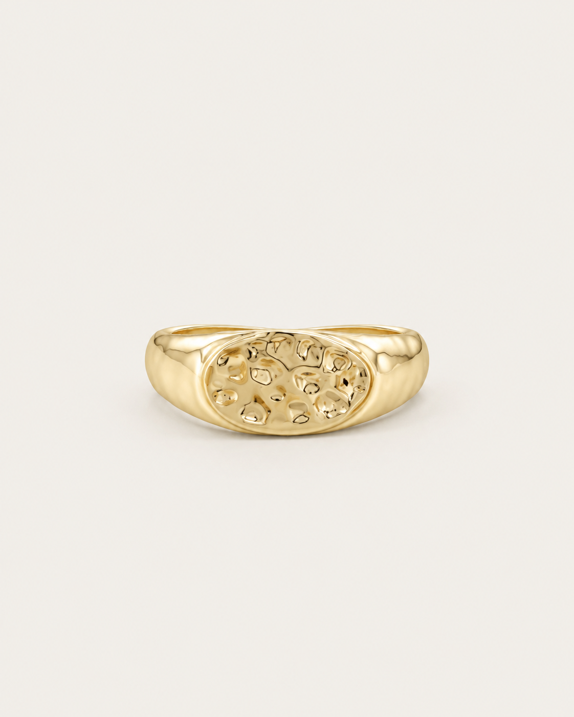 Gold-tone ring with a hammered oval dome, front view.