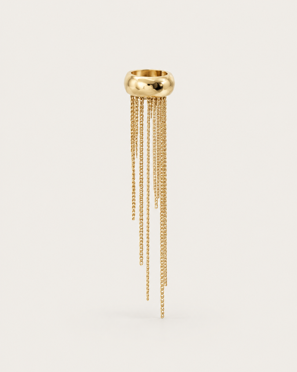 One gold-tone ear cuff with uneven chain fringes, shown on its own.