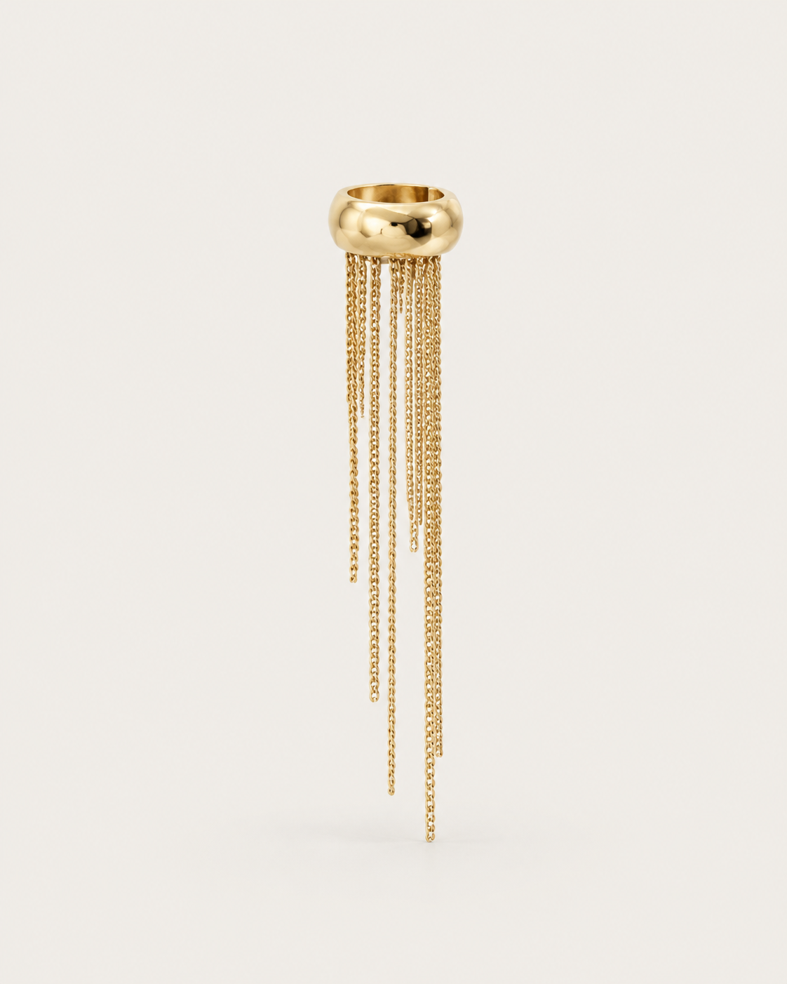 One gold-tone ear cuff with uneven chain fringes, shown on its own.