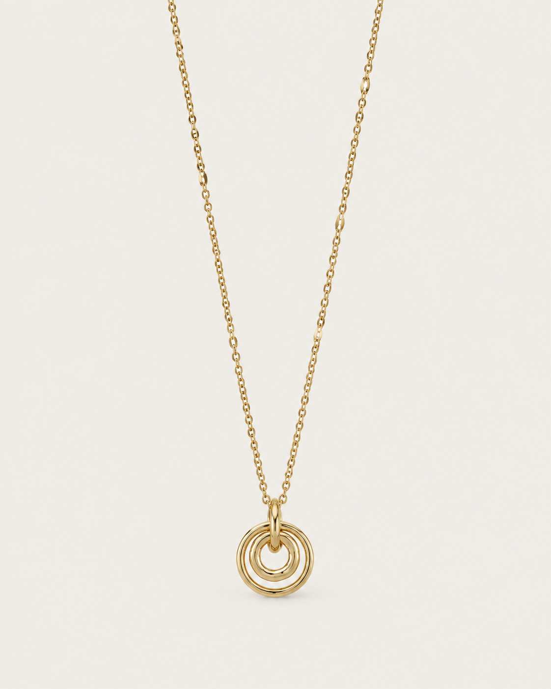 Gold-tone necklace with concentric circle pendants, front view.