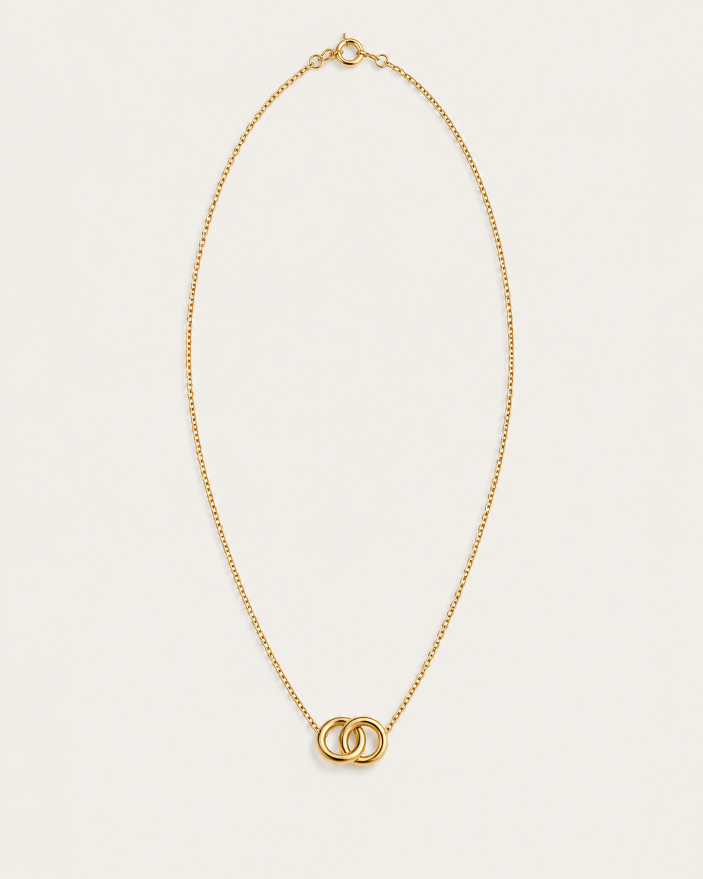 Gold-tone necklace with two interlocking circle pendants, front view.
