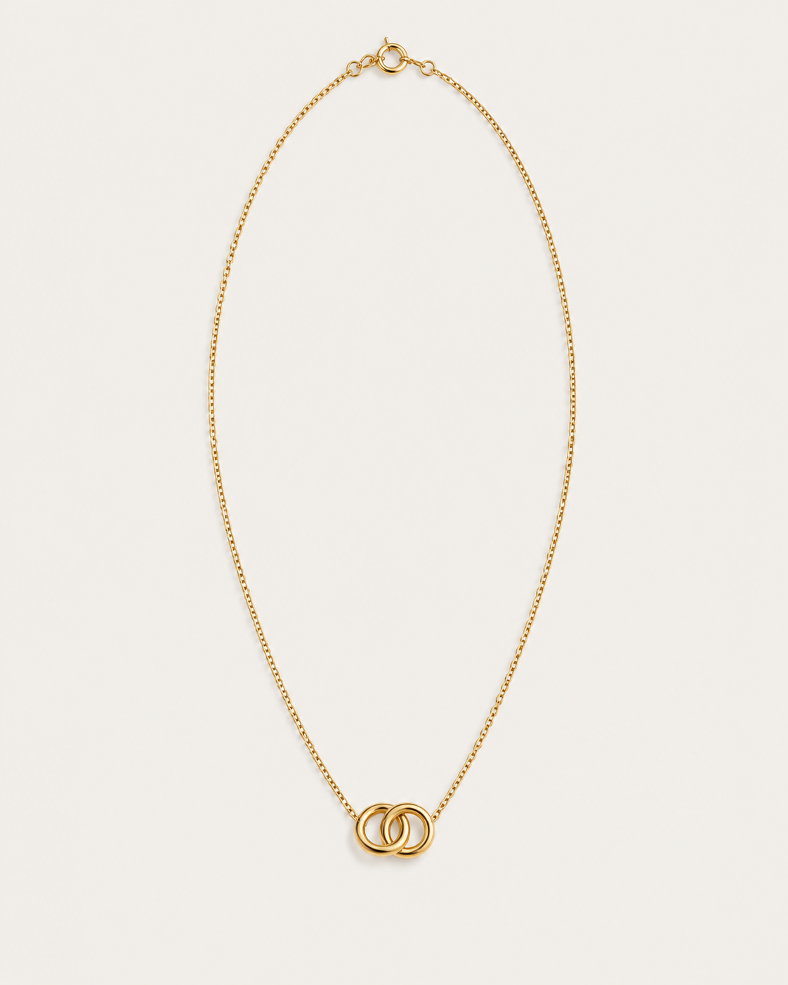 Gold-tone necklace with two interlocking circle pendants, front view.