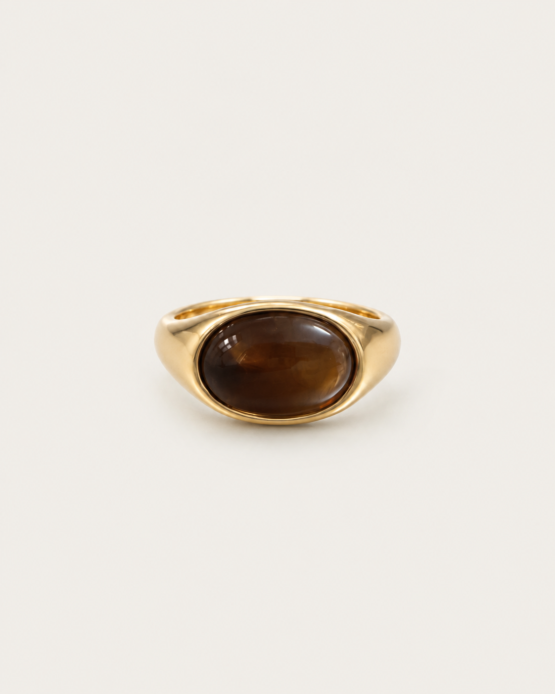Gold-tone ring with a horizontal brown oval accent, front view.