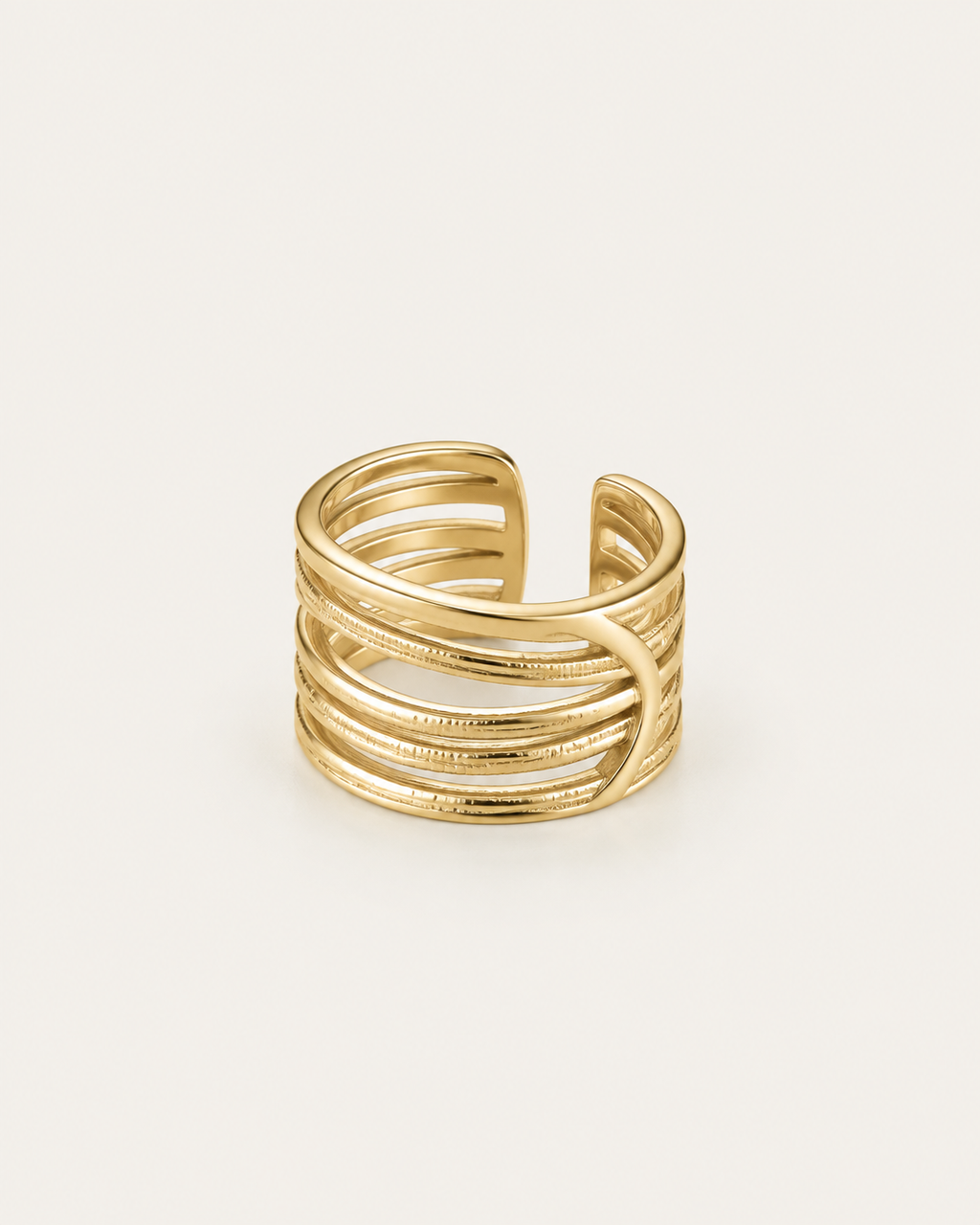 Gold-tone ring with multiple crisscrossing rails, angled view showing the open back.
