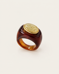 Brown ring with a pale oval inset and gold-tone rim, front view.