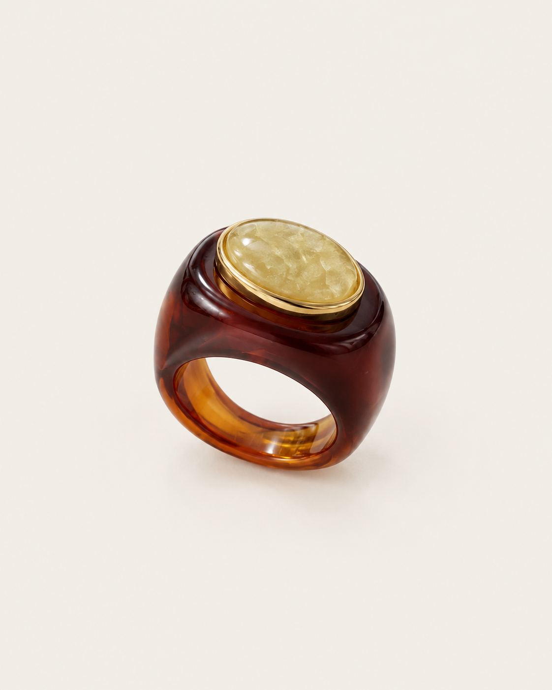Brown ring with a pale oval inset and gold-tone rim, front view.