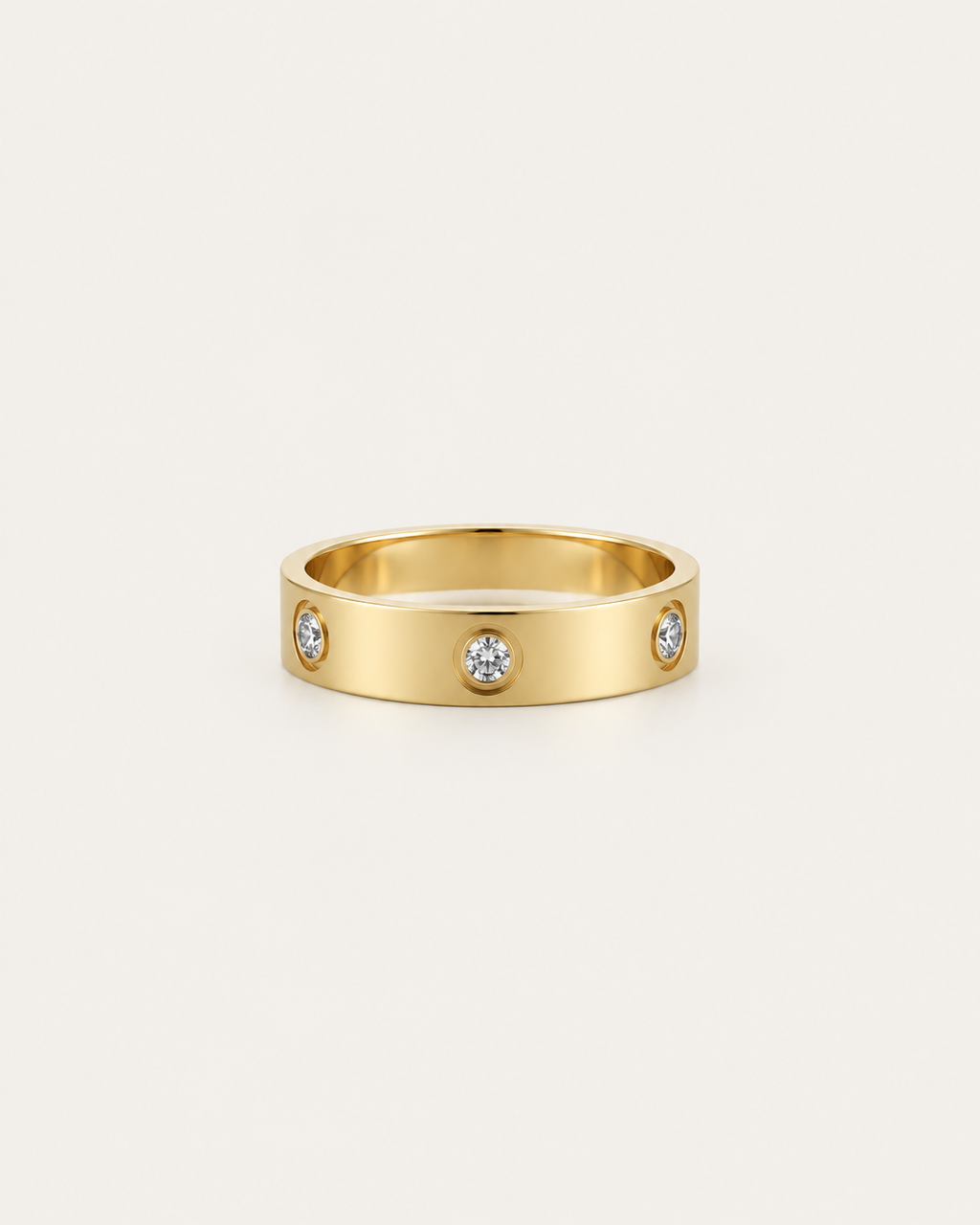 Gold-tone band ring with spaced round bezel-set stone accents, front view.