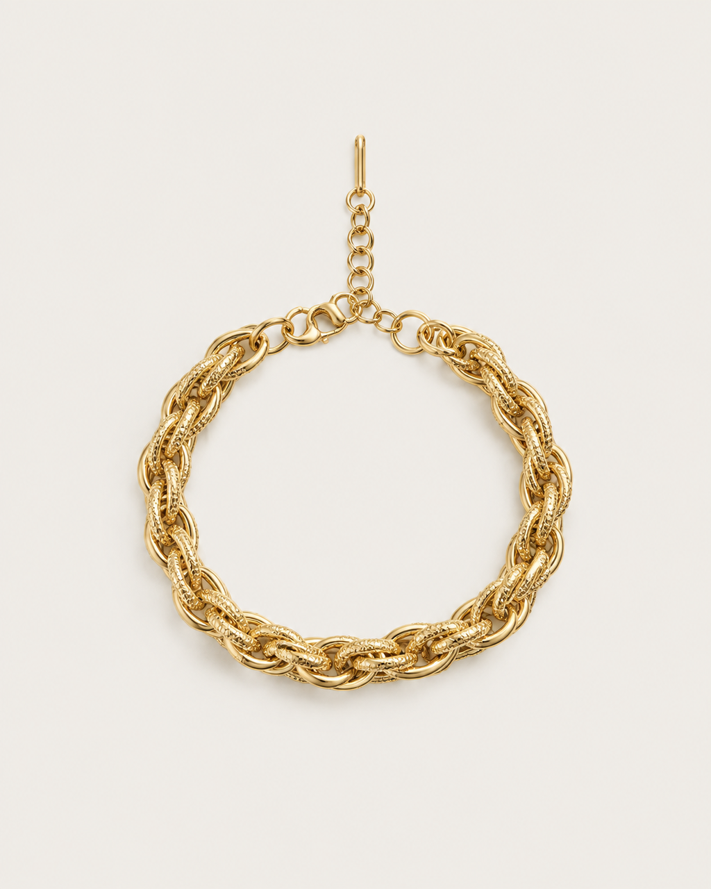 Gold-tone bracelet with chunky double links, laid out with an extension chain.