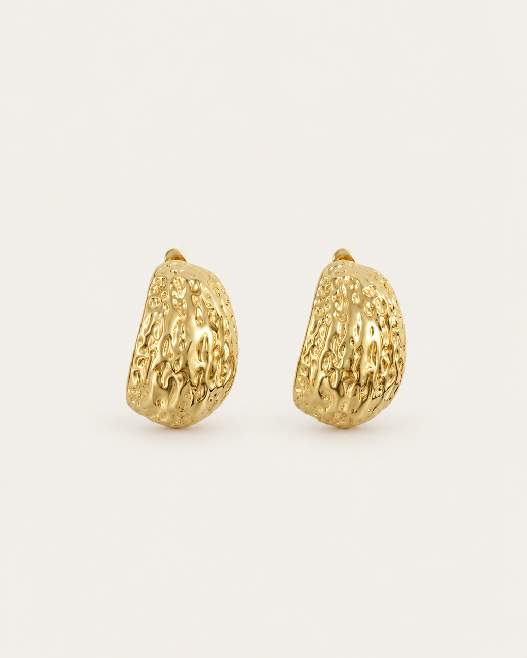 Pair of broad gold-tone hoop earrings with an irregular textured surface, shown together.