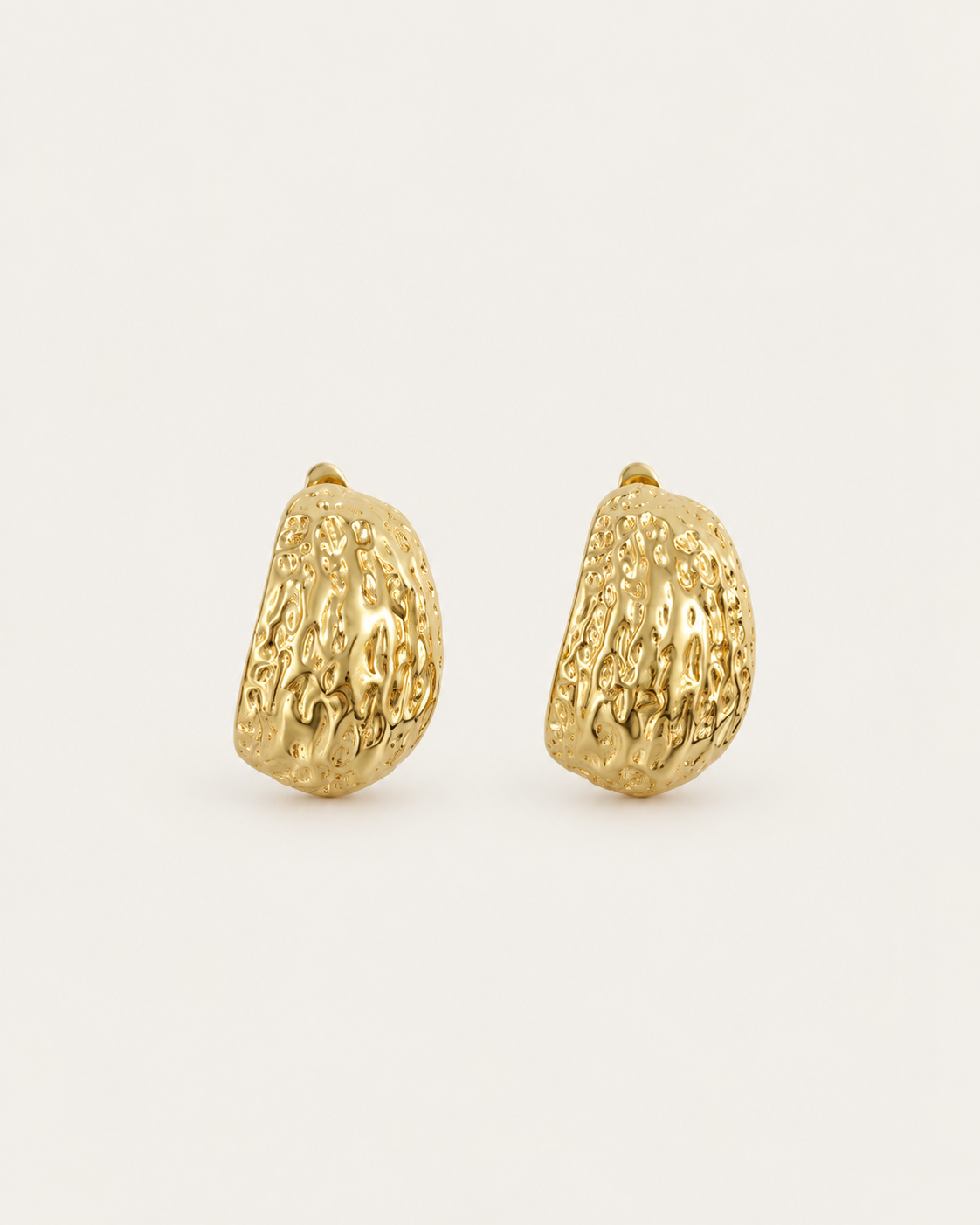 Pair of broad gold-tone hoop earrings with an irregular textured surface, shown together.
