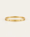 Gold-tone bangle with screw motifs and alternating stone accents, front view.