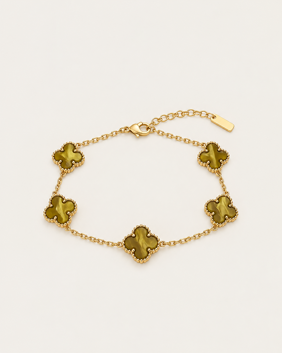 Gold-tone chain bracelet with five clover stations, laid out with matching gold-tone clovers.