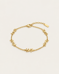 Gold-tone chain bracelet with repeated monogram-style stations, laid out.