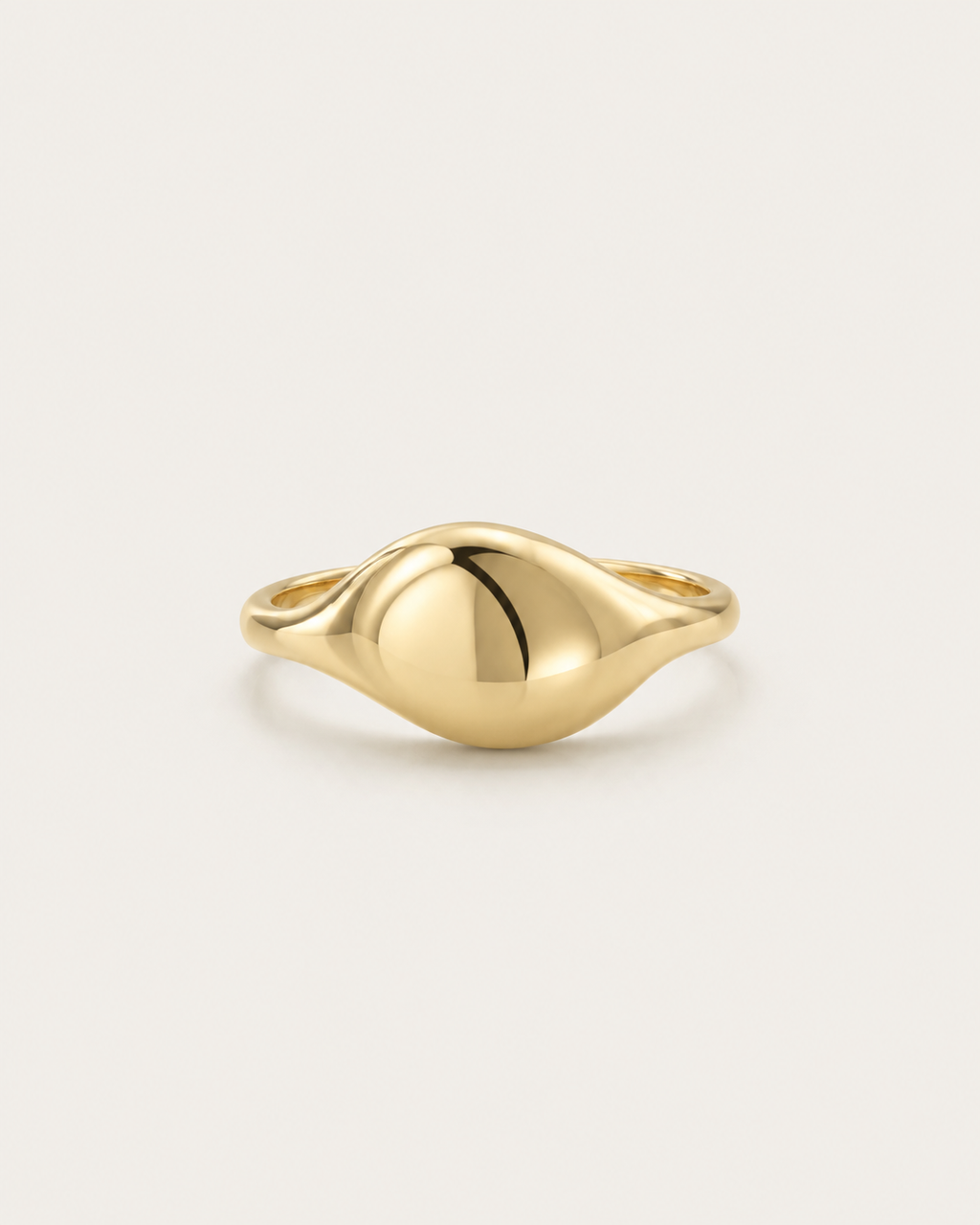 Gold-tone ring with an asymmetric domed front, front view.