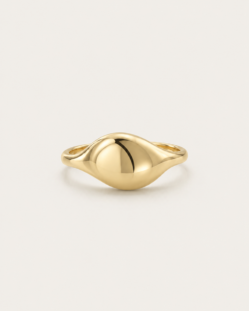 Gold-tone ring with an asymmetric domed front, front view.