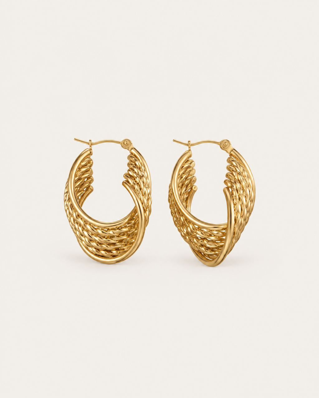 Pair of gold-tone oval hoop earrings with a woven pattern, shown together.