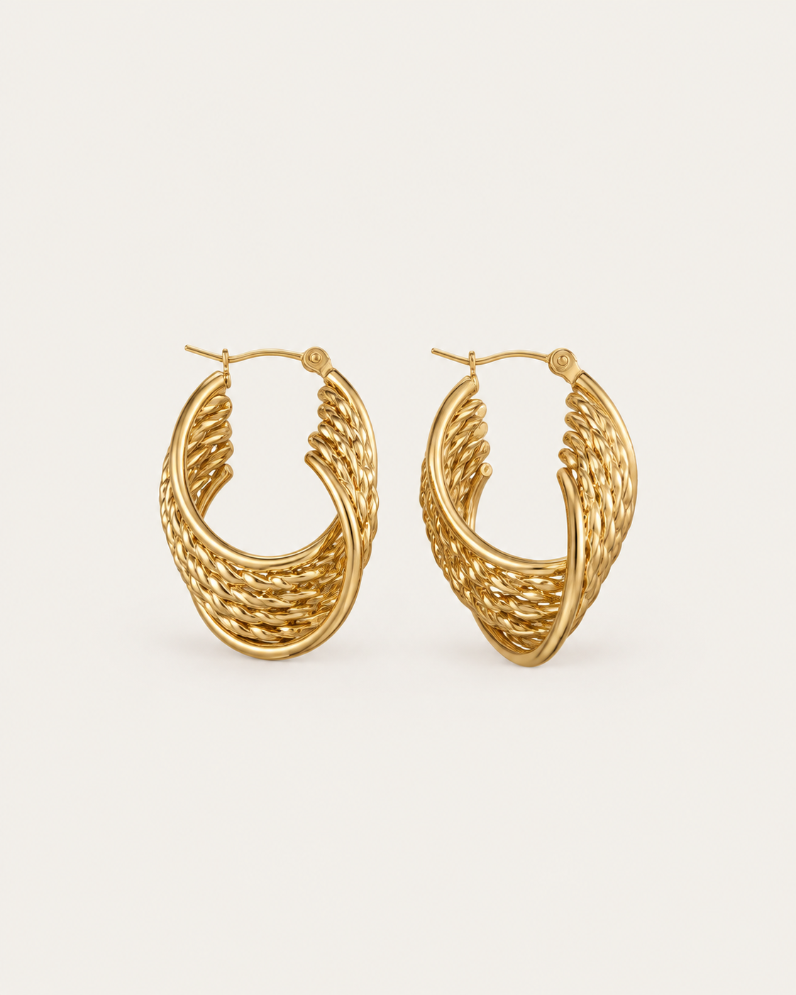 Pair of gold-tone oval hoop earrings with a woven pattern, shown together.