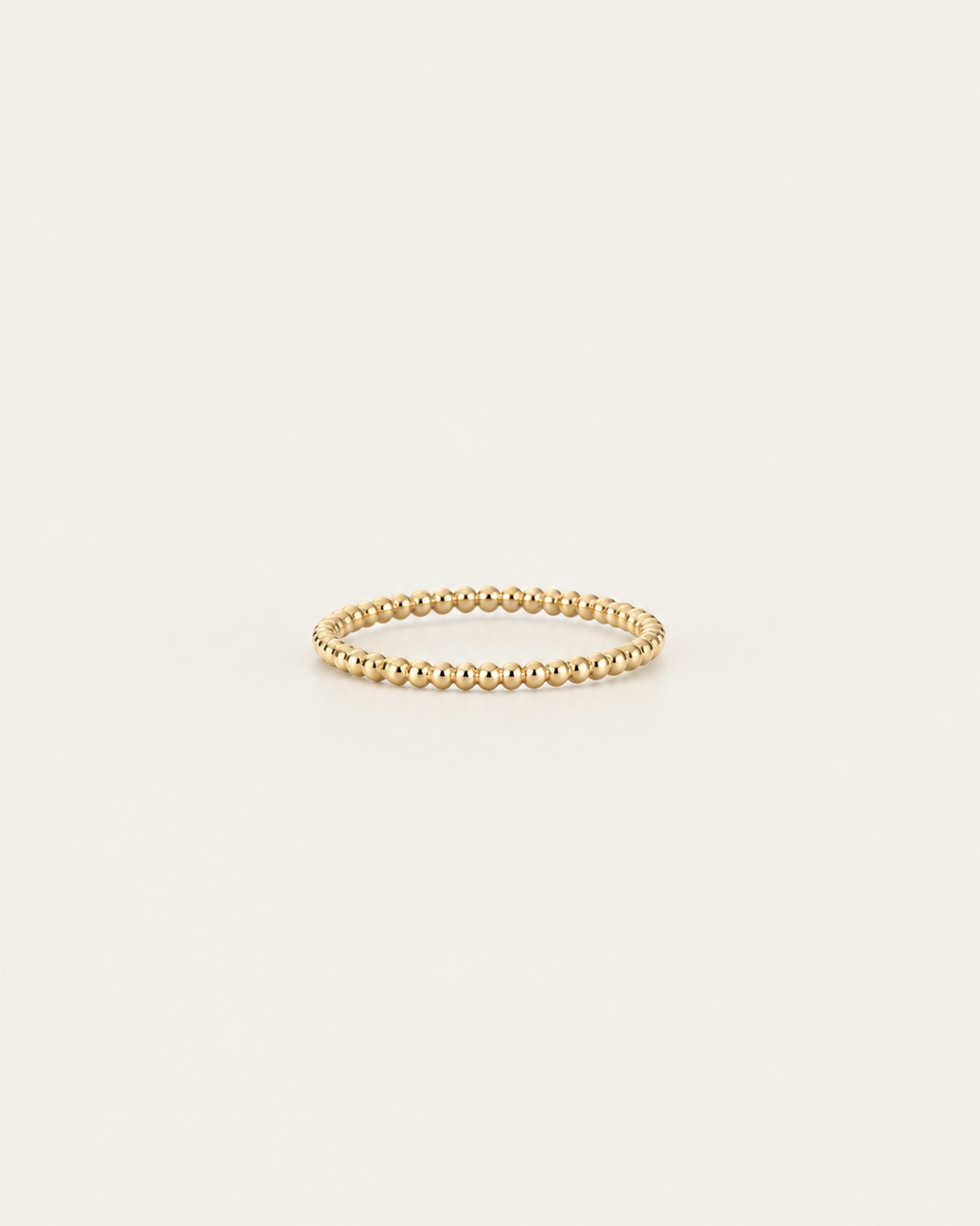 Gold-tone beaded band ring, front view.