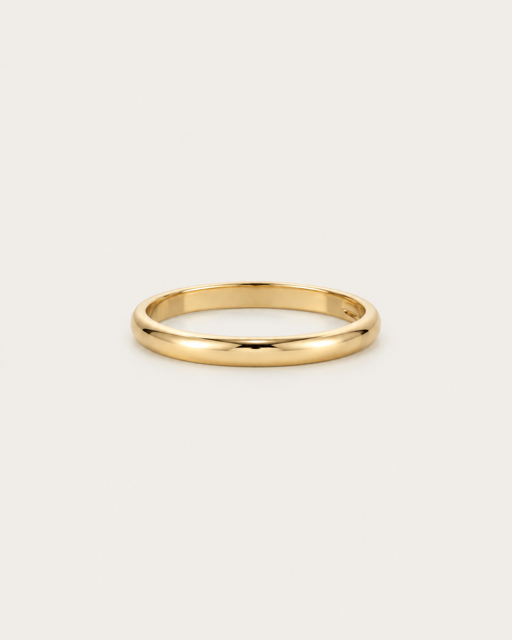 Slim plain gold-tone band ring, front view.