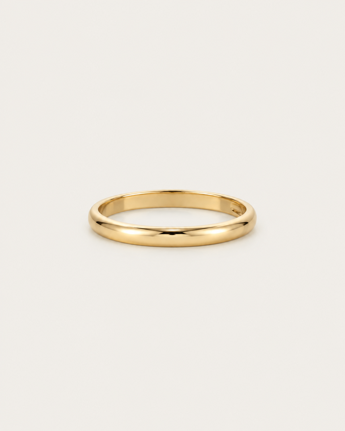 Slim plain gold-tone band ring, front view.