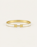 White enamel bangle with gold-tone edges and an H-shaped clasp, front view.