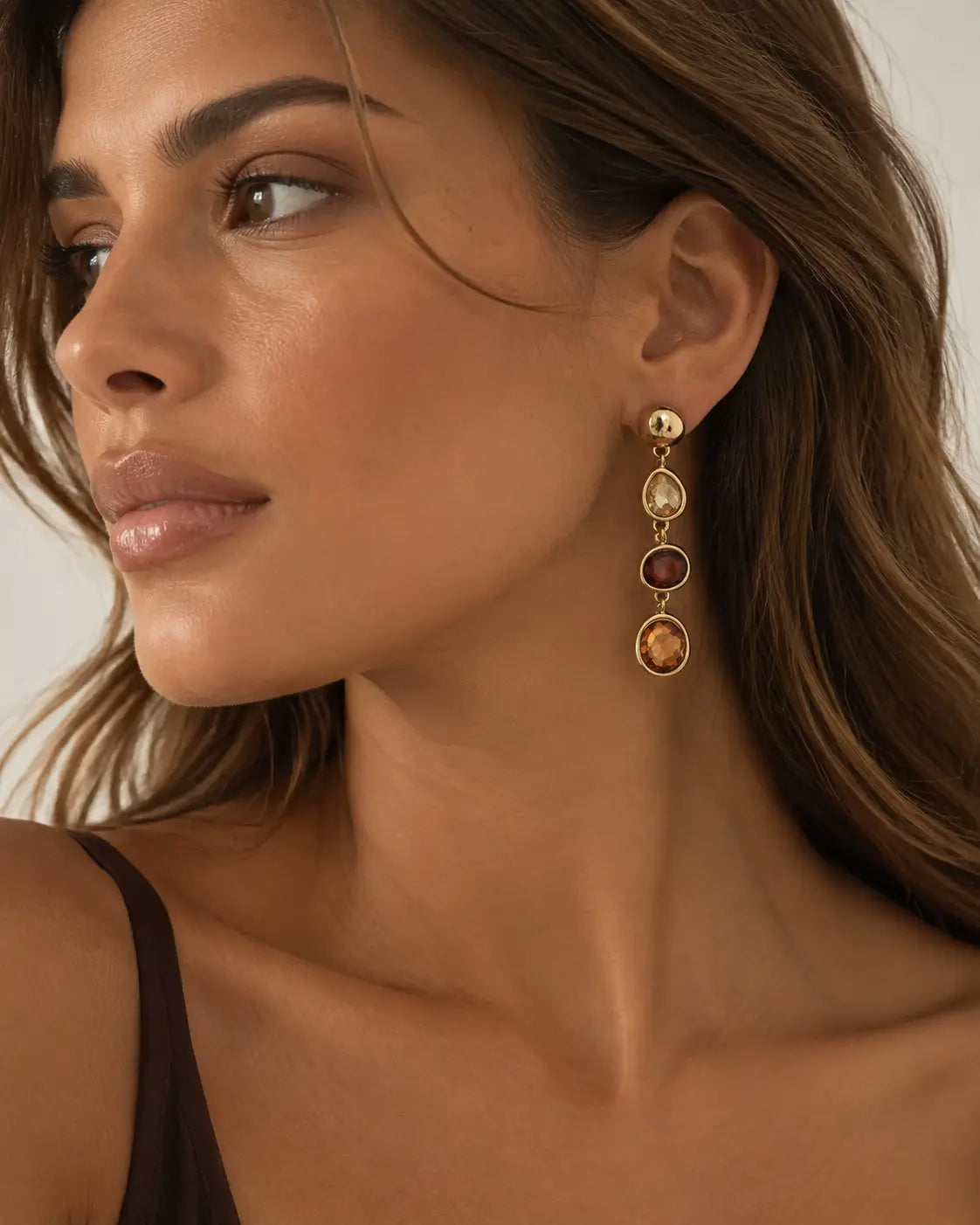 Tiered accent drop earring worn in profile.