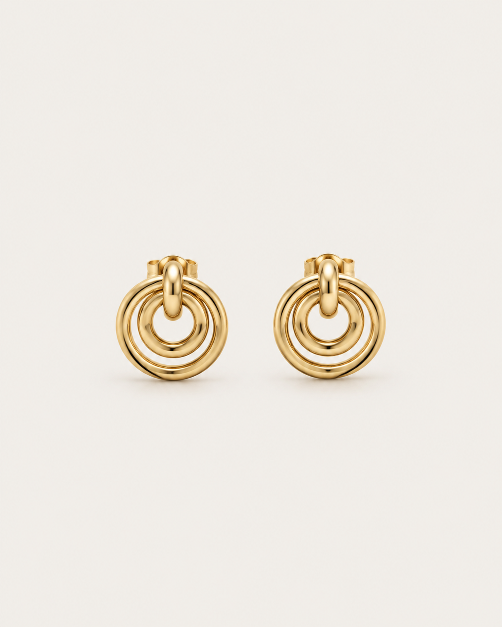 Pair of gold-tone concentric circle drop earrings, shown together.