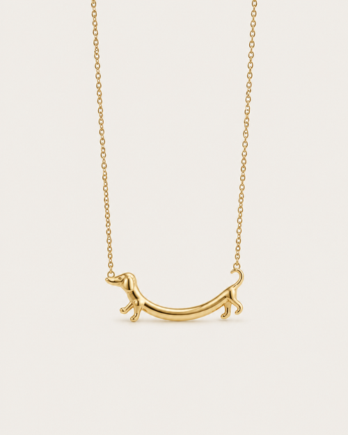 Gold-tone necklace with a dachshund-shaped pendant, front view.