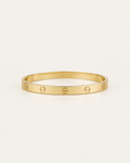 Plain gold-tone bangle with engraved screw motifs, front view.